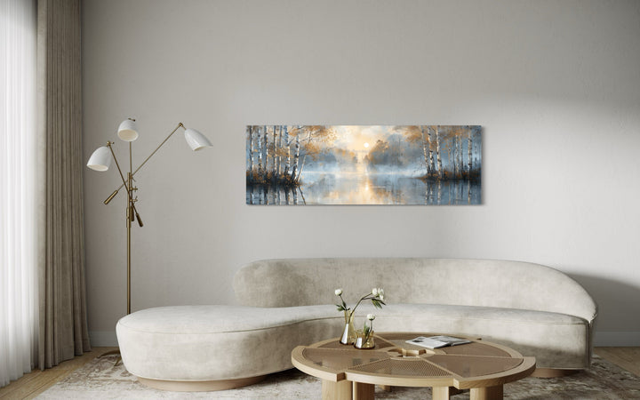 Silver birch trees forest long narrow horizontal wall art above a curved sofa in a living room.