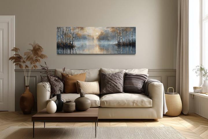 Silver birch trees forest long narrow horizontal wall art above a beige sofa in a living room.