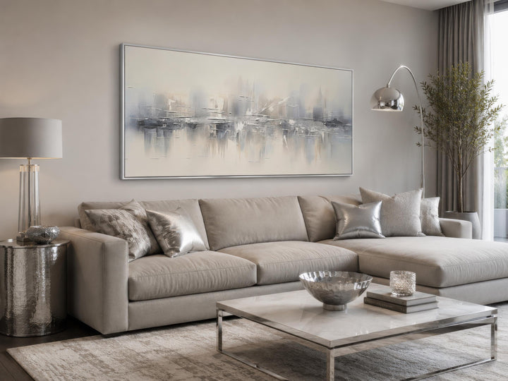 Silver grey and white abstract horizontal canvas wall art hanging above a neutral sectional sofa.