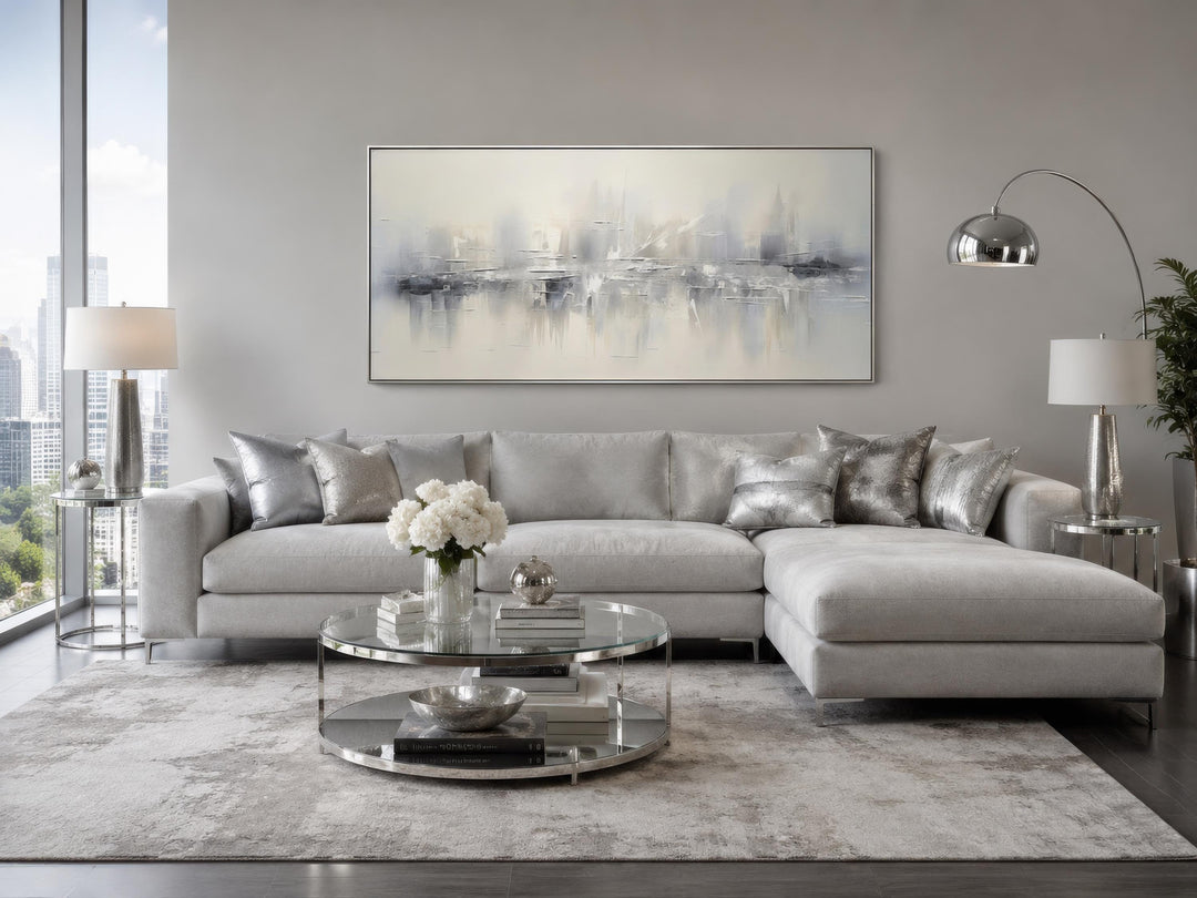 Silver grey and white abstract canvas wall art hanging above a grey sectional sofa in a living room.