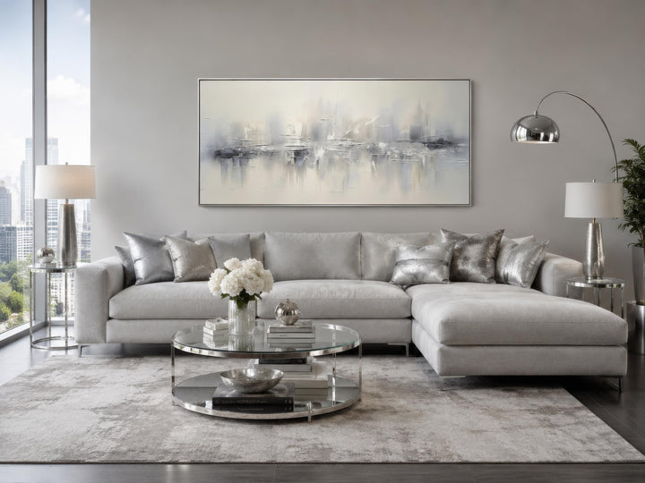 Silver grey and white abstract canvas wall art hanging above a grey sectional sofa in a living room.