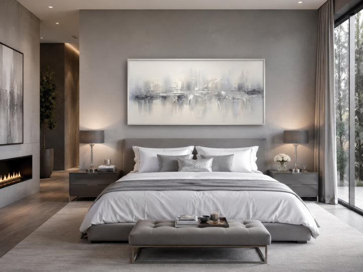 Silver grey and white abstract wall art hanging above a bed in a modern neutral bedroom.