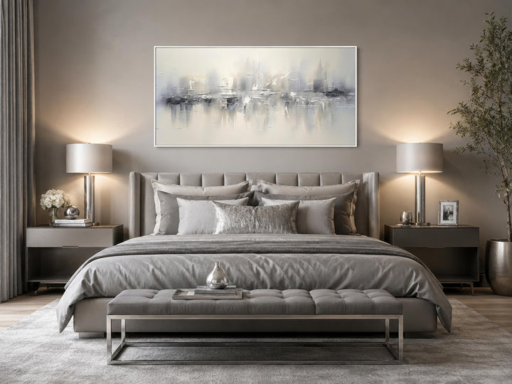 Silver grey and white abstract horizontal wall art hanging above a bed in a neutral bedroom.