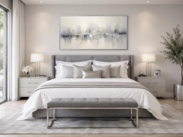 Silver grey and white abstract canvas wall art hanging above a bed in a modern neutral bedroom.