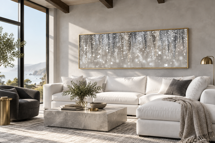 Modern horizontal canvas print featuring abstract silver and beige rain streaks above a sofa.