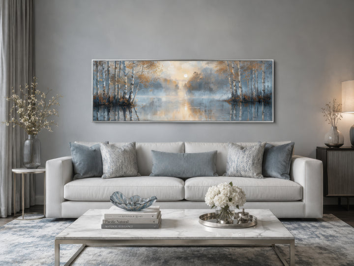 Silver birch trees forest long narrow horizontal wall art hanging above a white sofa in a room.