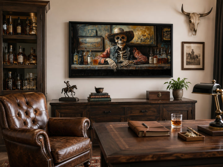 Skeleton cowboy barman framed canvas wall art in a rustic office with leather chair and desk.