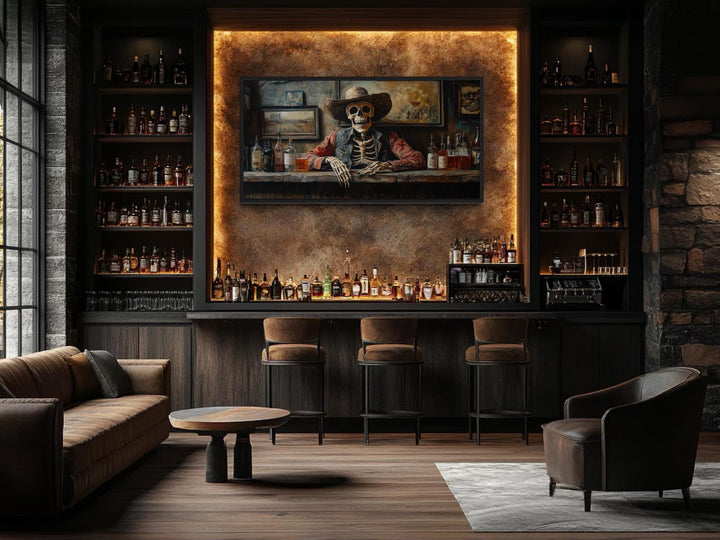 Framed canvas wall art of a skeleton cowboy barman in a saloon, displayed in a modern home bar.