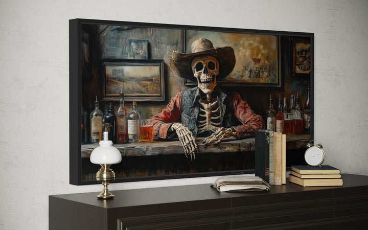 Skeleton cowboy barman framed canvas wall art displayed on a dark wood dresser with vintage decor.