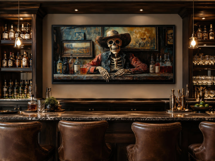 Framed canvas wall art of a skeleton cowboy bartender in a dimly lit Western saloon above a bar.