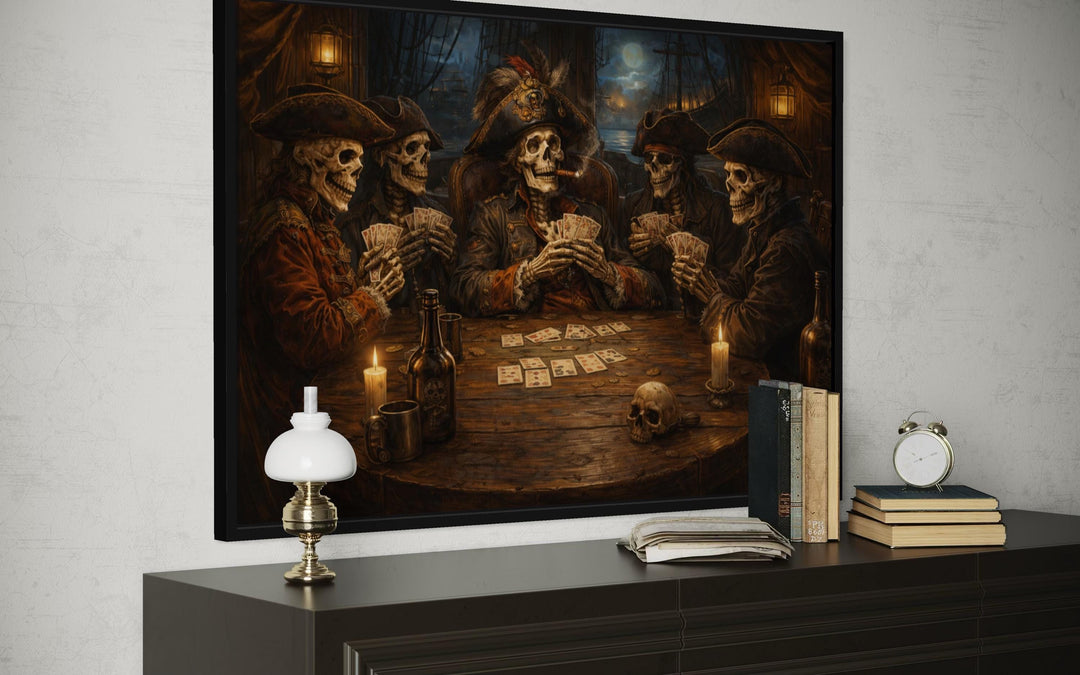 Framed wall art of skeleton pirates playing cards in a tavern, displayed above a dark wood dresser.