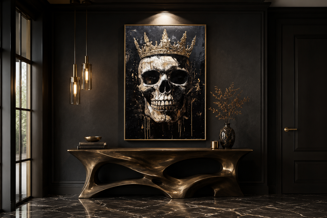 Skull Wearing Gold Crown Gothic Canvas Wall Art in a black-walled room above a bronze console table.