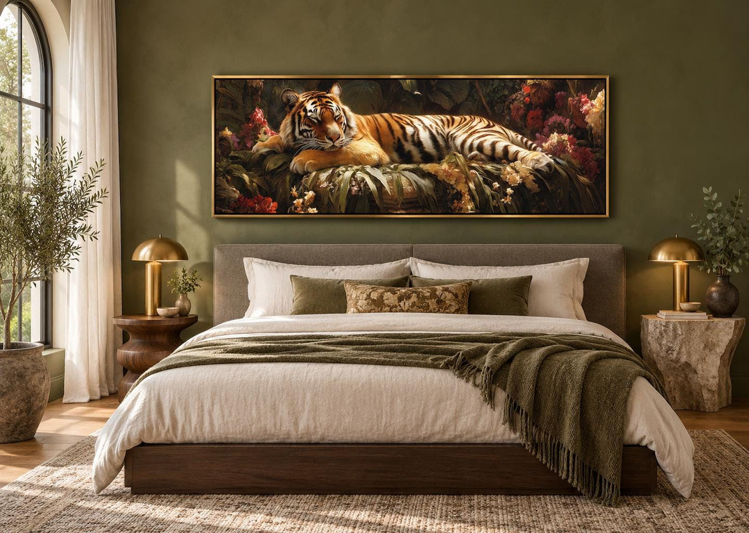 Sleeping tiger framed canvas wall art above a bed in a green bedroom with botanical accents.