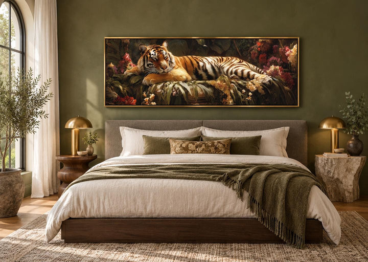 Sleeping tiger framed canvas wall art above a bed in a green bedroom with botanical accents.