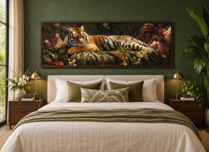 Sleeping tiger framed canvas wall art above a bed in a green bedroom with botanical decor.