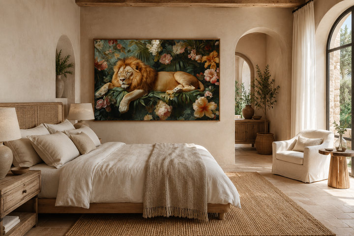 Framed canvas wall art of a sleeping lion in a floral jungle above a bed in a neutral bedroom.