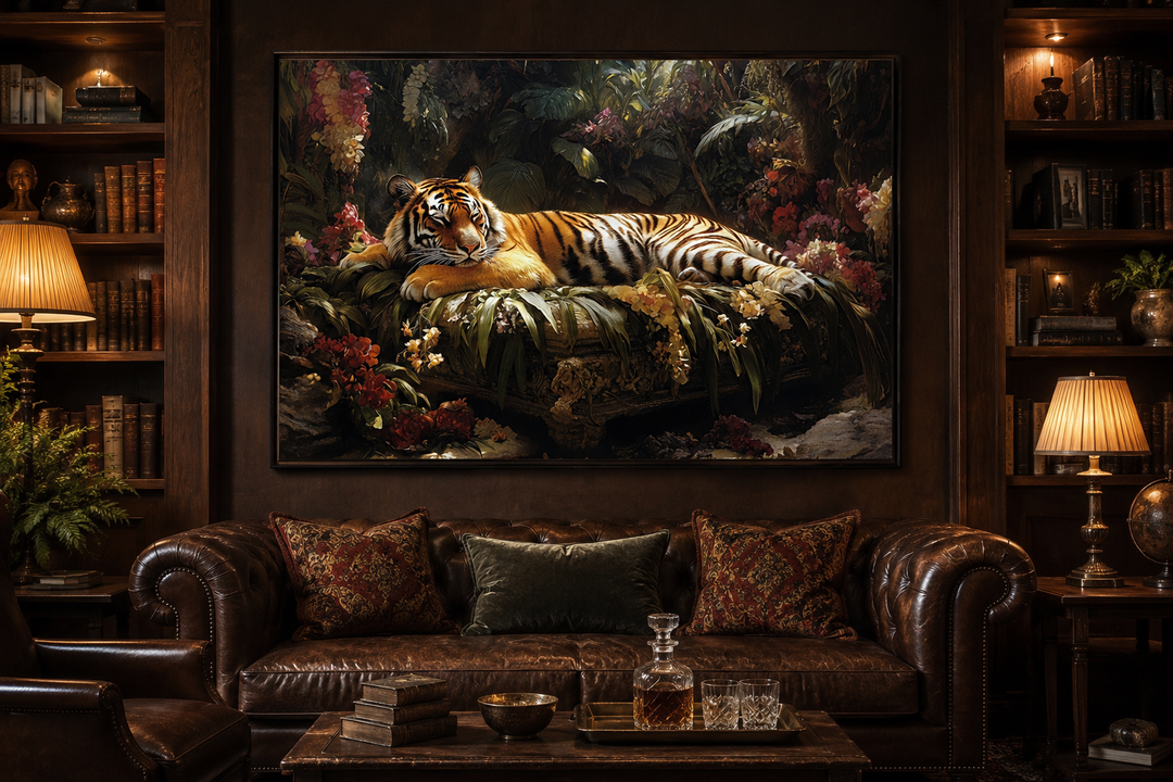 Framed canvas wall art of a tiger sleeping in a lush jungle, hanging above a leather sofa.