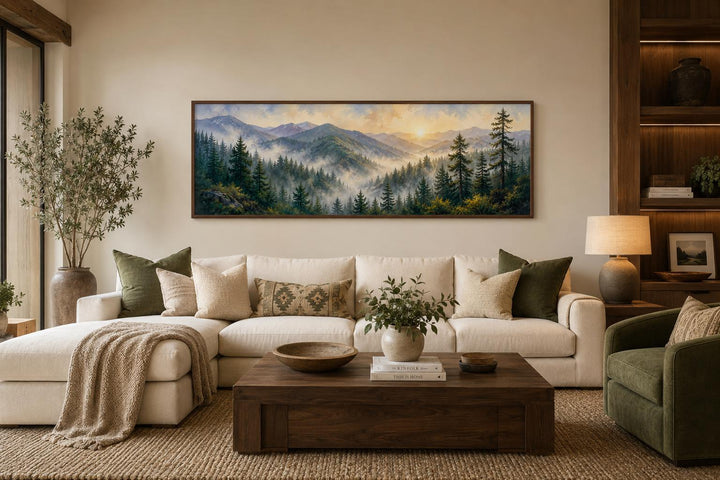 Smoky Mountains sunrise wall art featuring a pine forest landscape above a cream sectional couch.