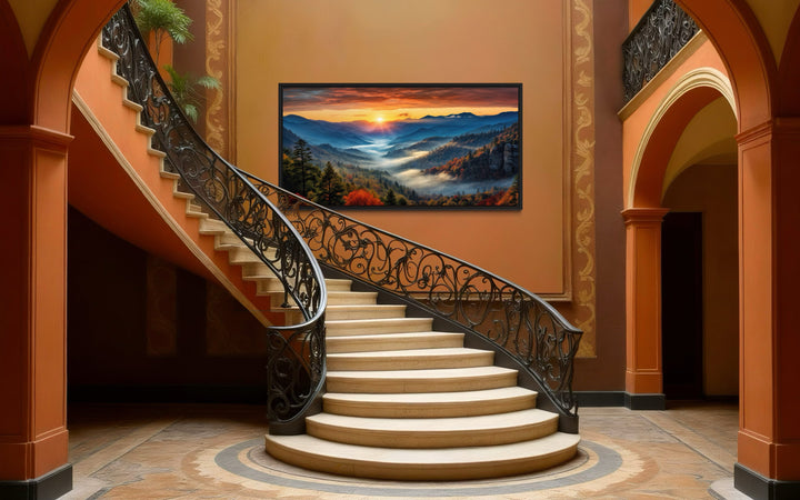 Smoky Mountains sunset canvas art displayed on a wall above a grand curved staircase.