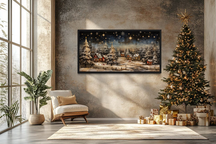 Snow-covered winter village at night wall art in a cozy room with a Christmas tree and gifts.