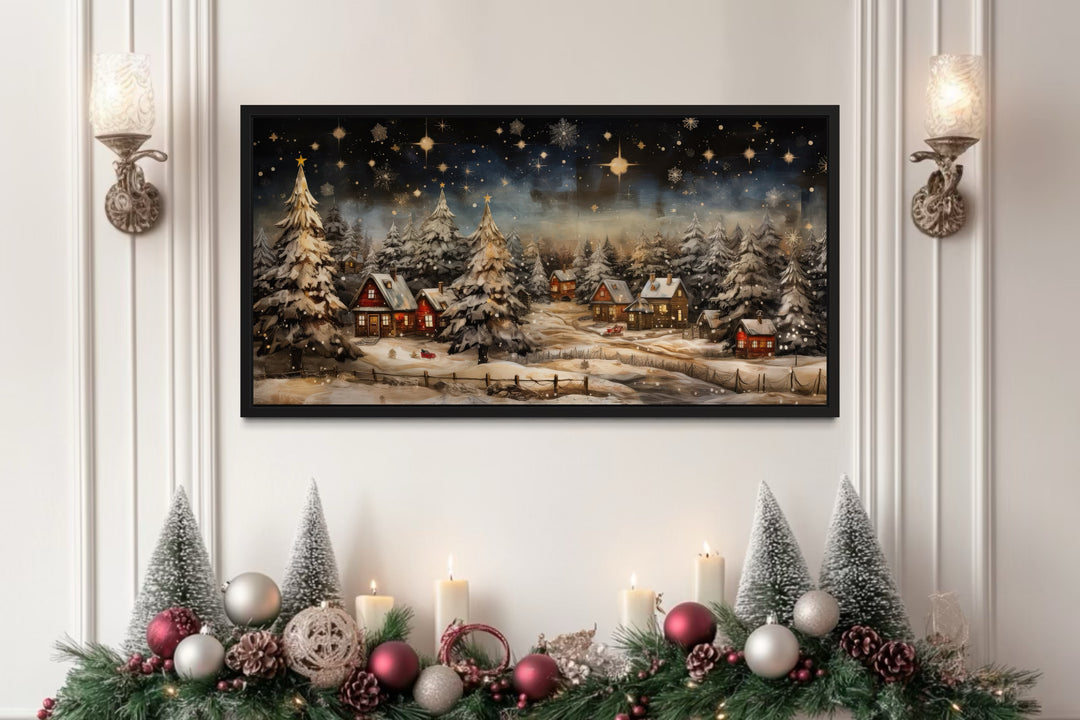 Snowy winter village wall art displayed over a decorated Christmas fireplace mantel.