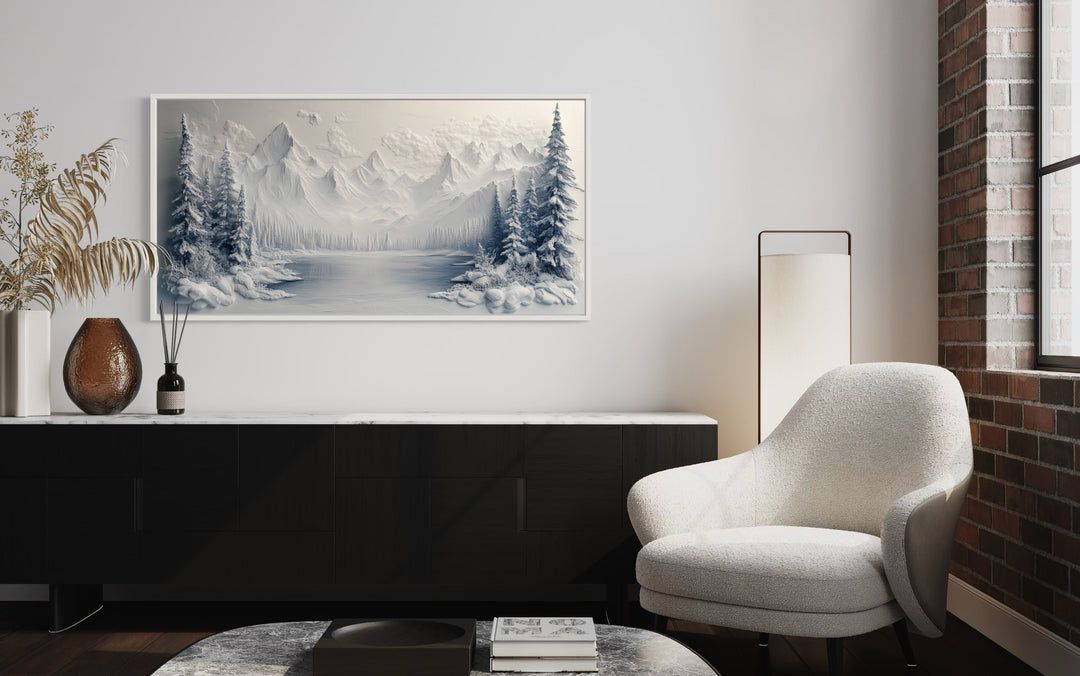 Snowy Mountain Lake With Pine Trees Winter Framed Canvas Wall Art in a living room with a white chair