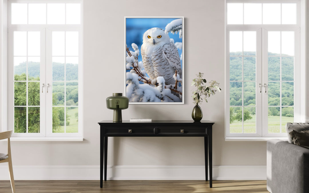Snowy Owl In Snow Photography Style Framed Canvas Wall Art above a black console table.