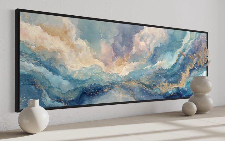 Long horizontal abstract wall art with soft blue, white, and gold marble-style flowing textures.