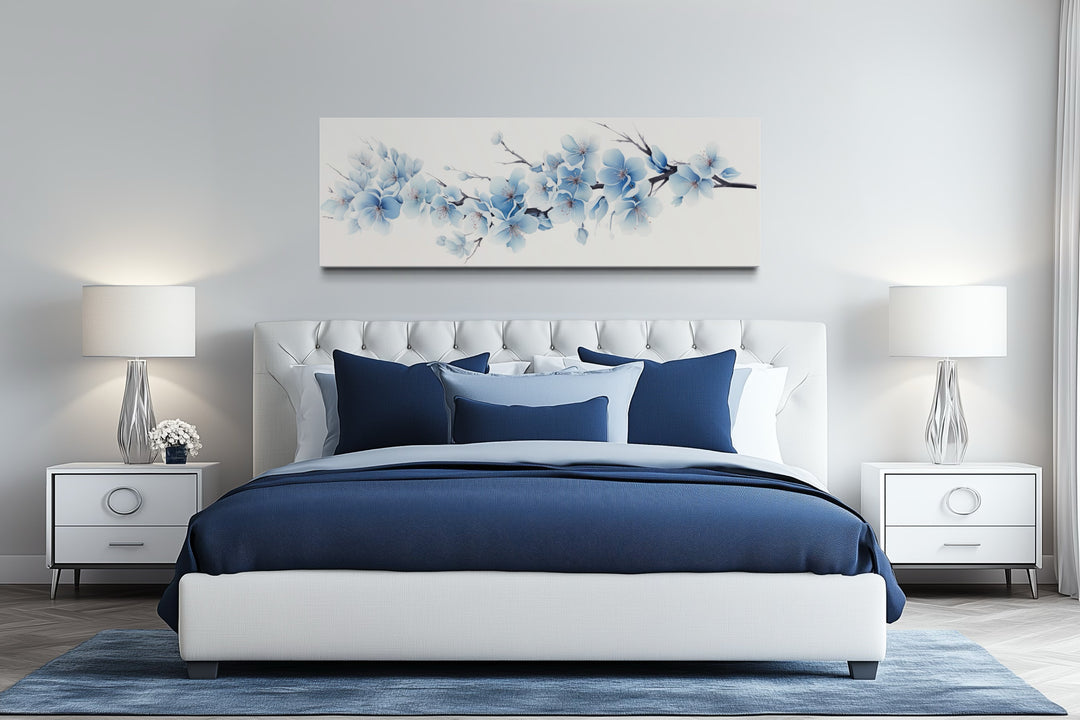 Soft blue blossom flowers long horizontal canvas wall art hanging above a bed in a bedroom.