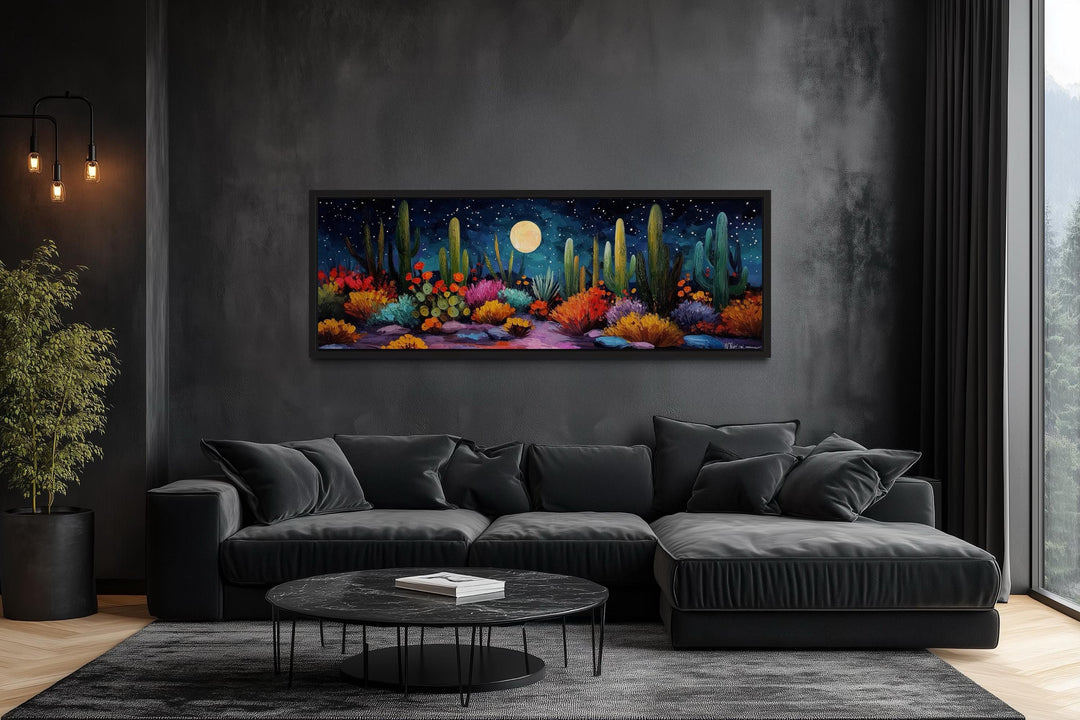 Southwest desert cacti under a moon and starry sky on a long horizontal canvas in a dark living room