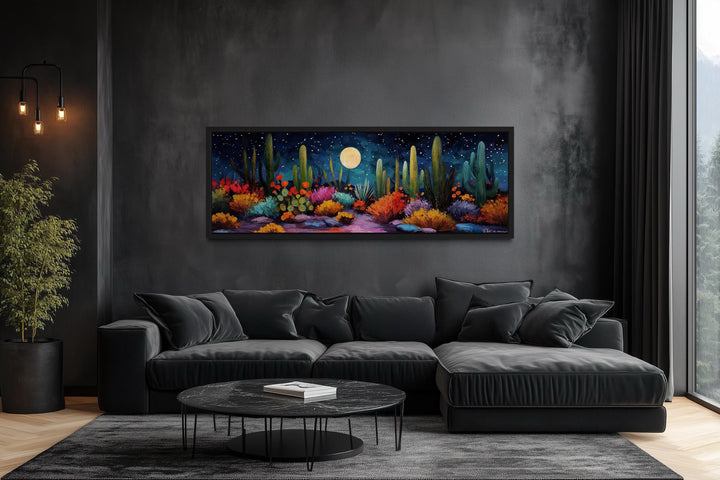 Southwest desert cacti under a moon and starry sky on a long horizontal canvas in a dark living room