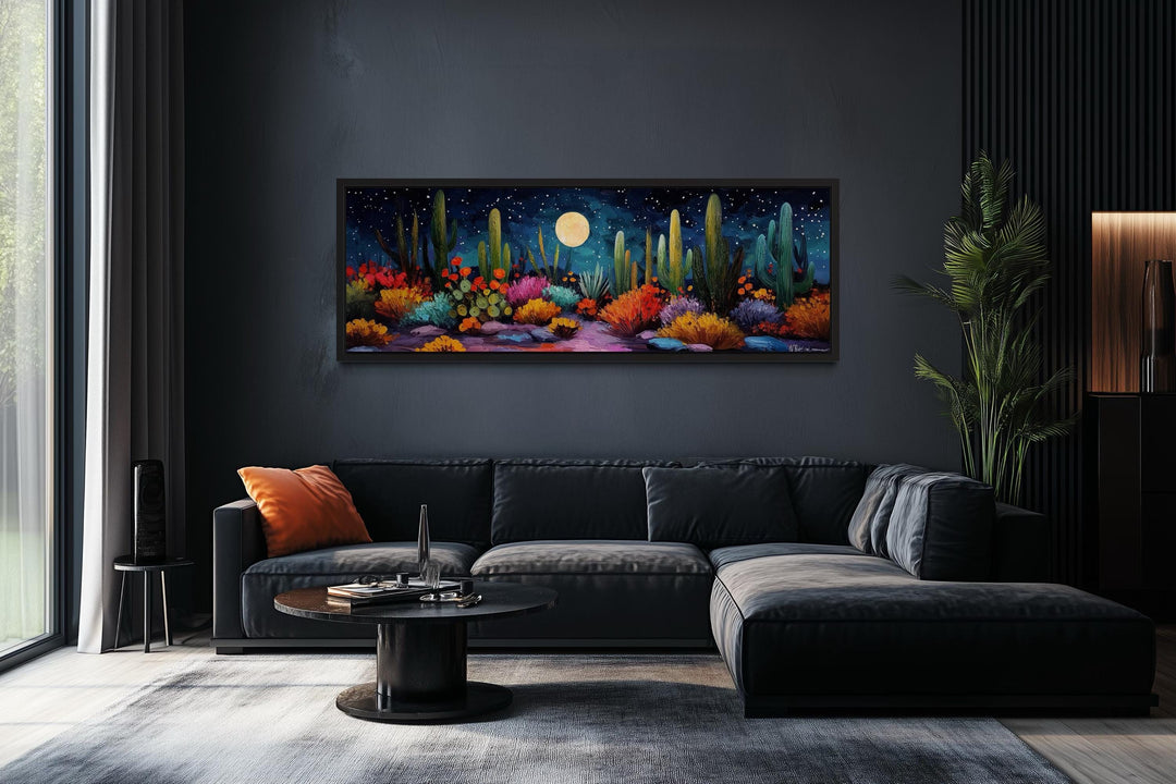 Southwest desert cacti under a moon and starry sky on a long horizontal canvas in a dark room.