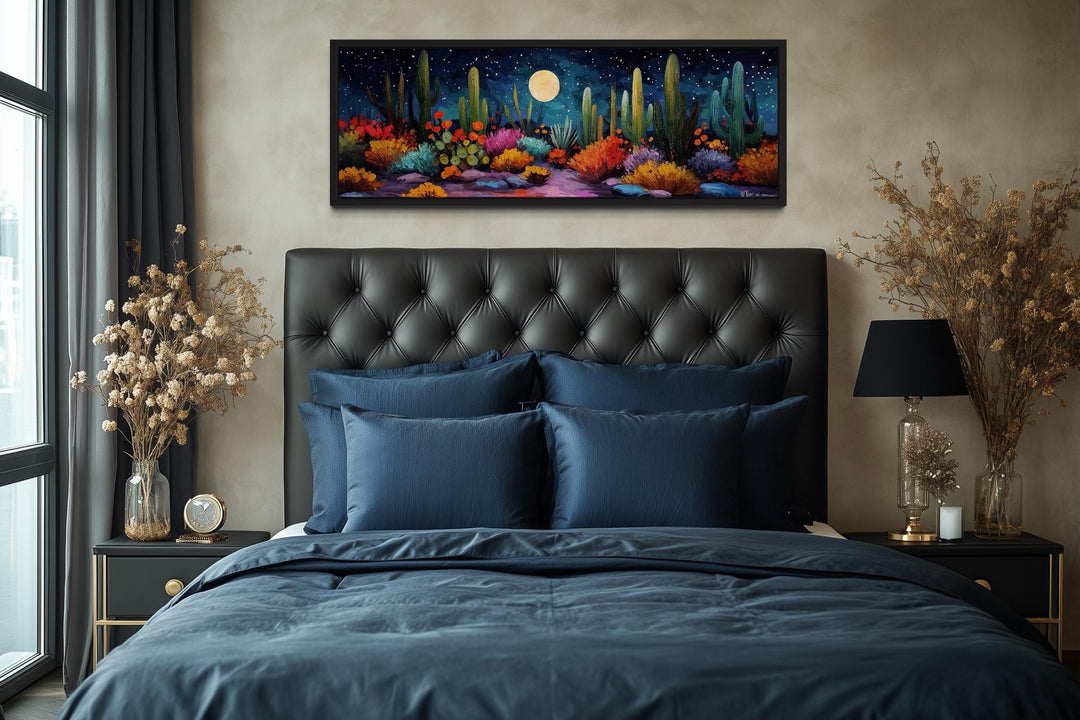 Southwest desert cacti under a moon and starry sky long horizontal canvas art above a bed.