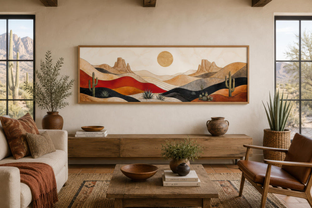 Southwest desert landscape wall art with abstract mountains, cactus, and golden sun above a sofa.