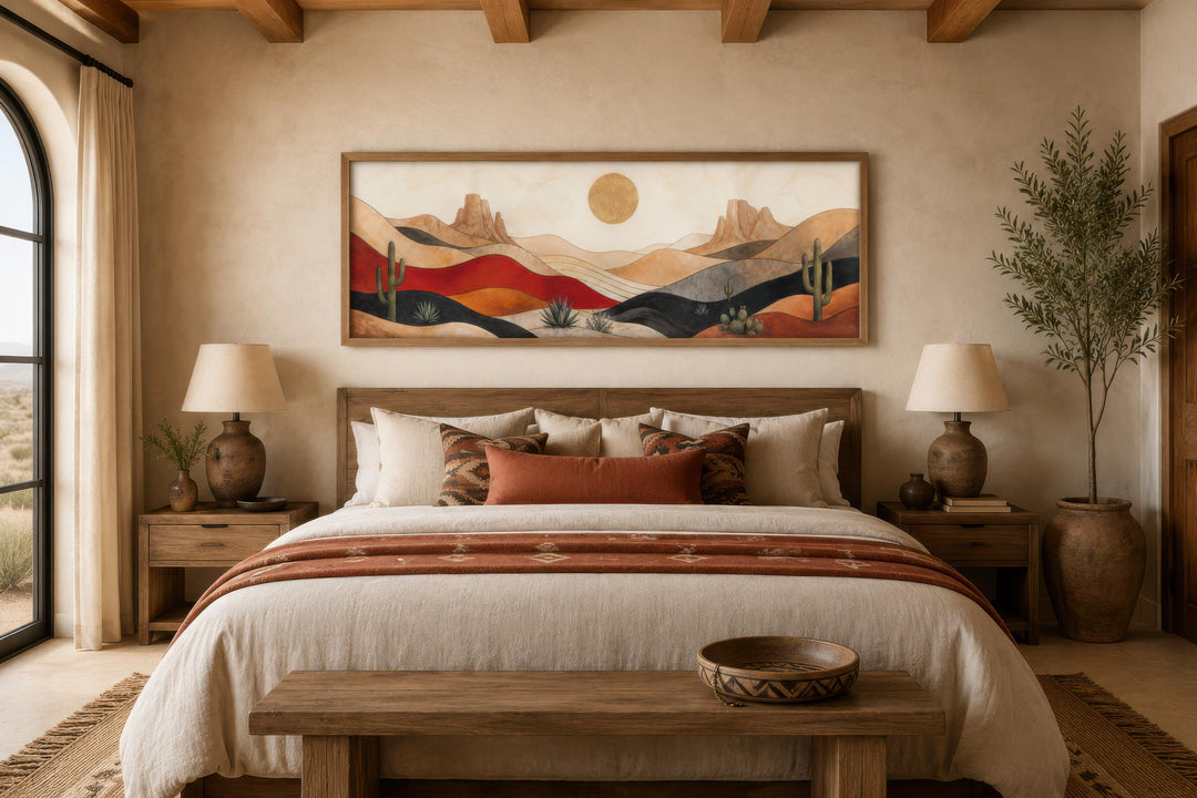 Southwest desert landscape wall art with cactus and golden sun above a bed in a rustic bedroom.