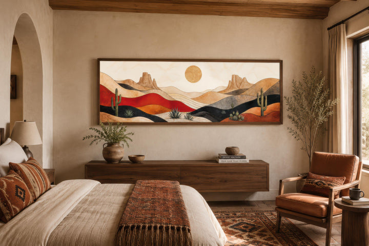 Long horizontal Southwest desert canvas print with cactus and mountains above a bedroom dresser.