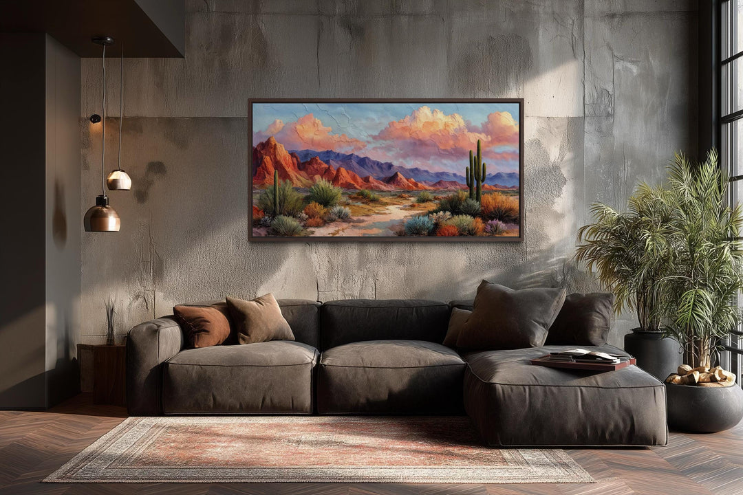 A horizontal rustic canvas print of a vibrant Southwest desert landscape above a modern sofa.