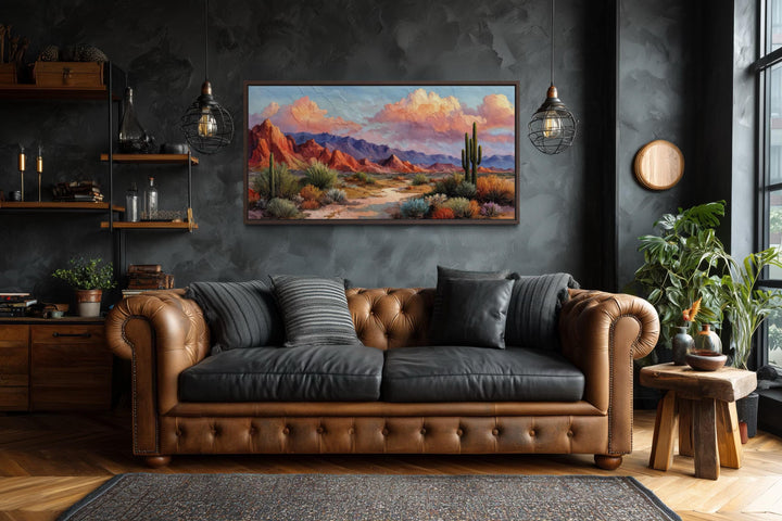 A horizontal canvas print of a colorful Southwest desert landscape hangs on a dark textured wall.