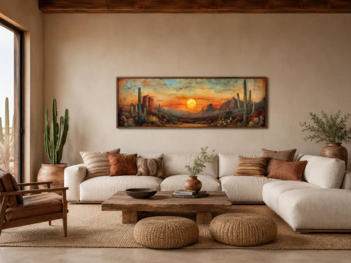 Panoramic Southwestern wall art of a desert sunset with saguaro cacti above a modern white sofa.