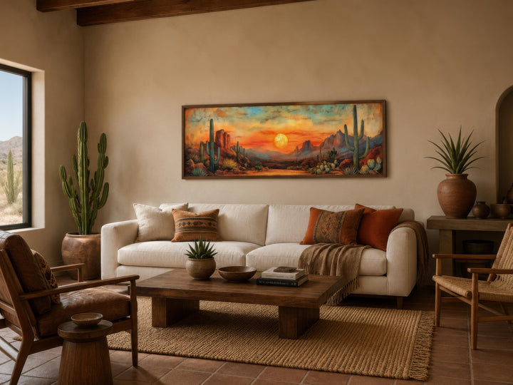 Panoramic desert sunset canvas print with saguaro cacti hanging above a sofa in a modern living room