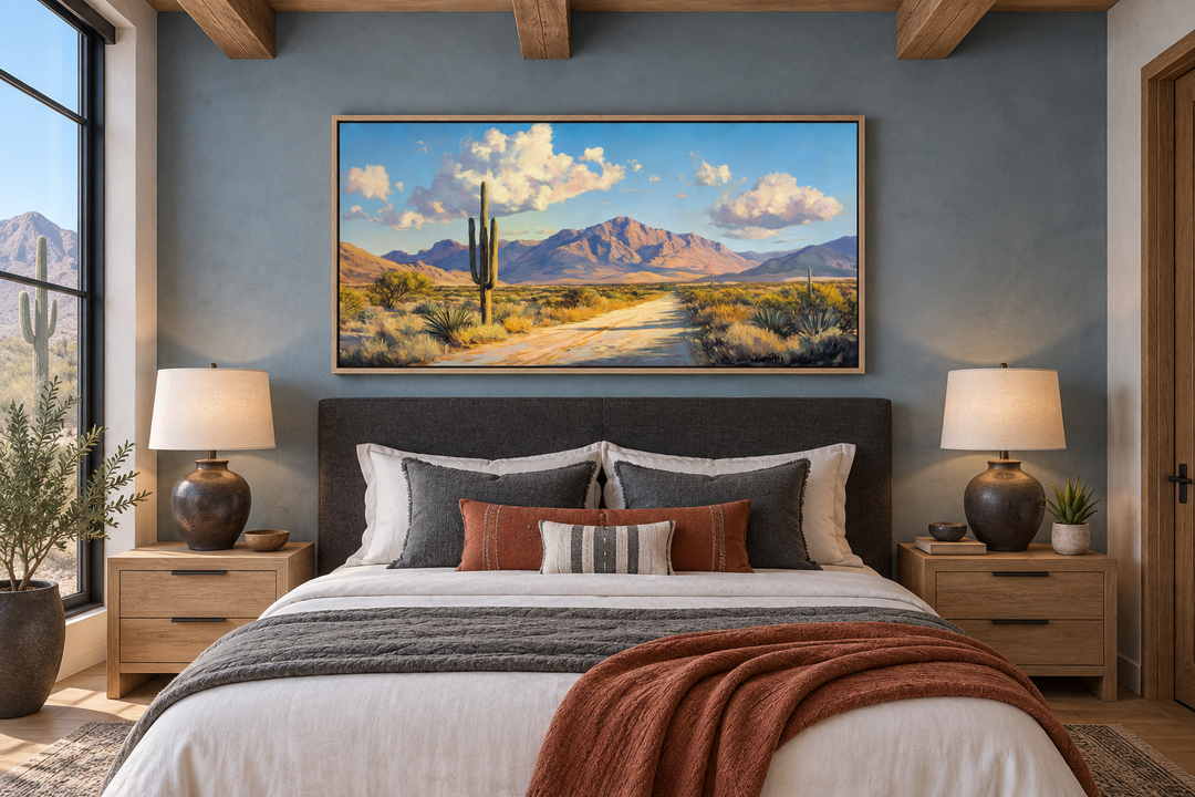 Southwestern desert landscape canvas wall art featuring a saguaro cactus and mountains over a bed.