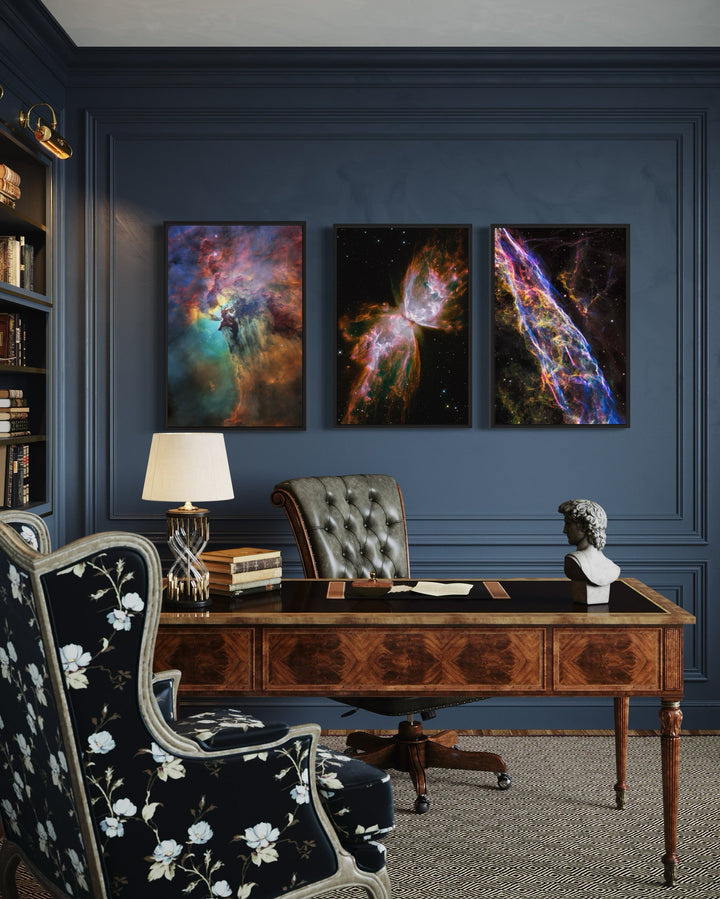 Set of 3 space nebula wall art prints featuring the Lagoon, Butterfly, and Veil nebulae in an office.