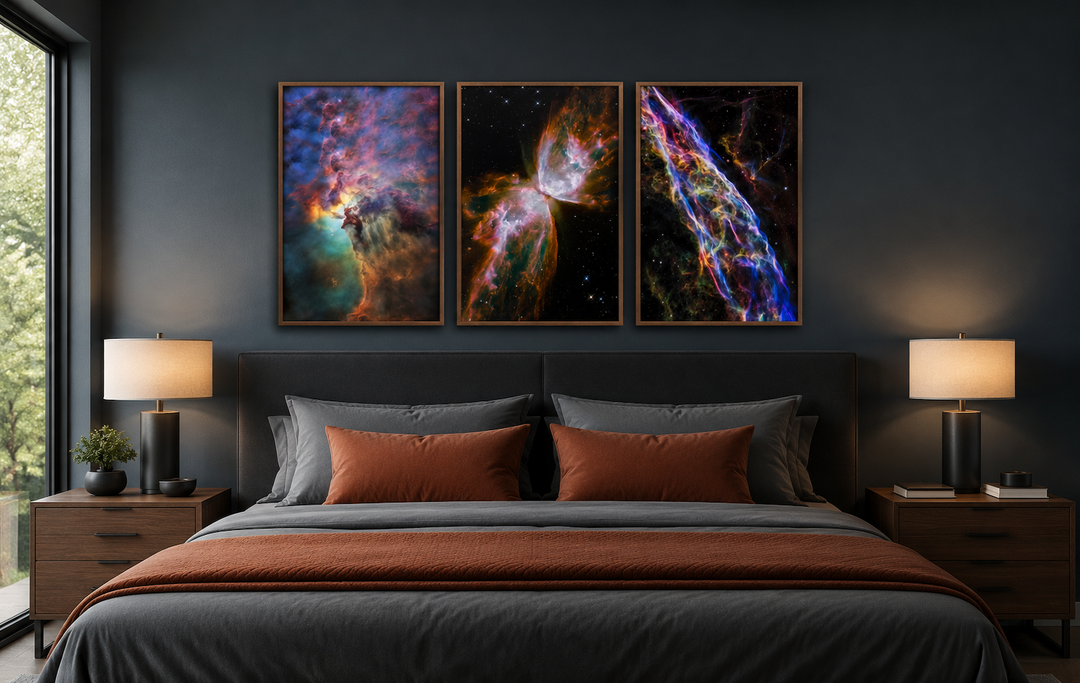 Set of 3 framed Hubble space nebula photographs hanging above a bed in a modern dark bedroom.