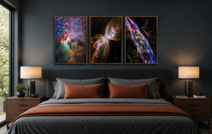 Set of 3 framed Hubble space nebula photographs hanging above a bed in a modern dark bedroom.
