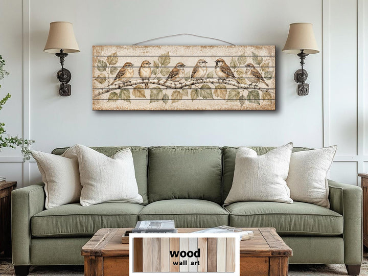Sparrows on Birch Tree Branch Distressed Wood Wall Art hanging above a green sofa.