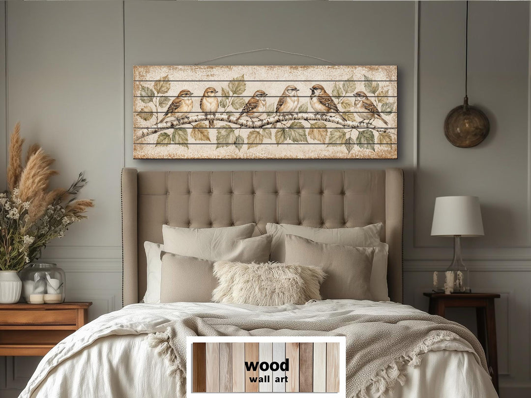 Sparrows on Birch Tree Branch wall art printed on horizontal wood planks above a neutral bed.