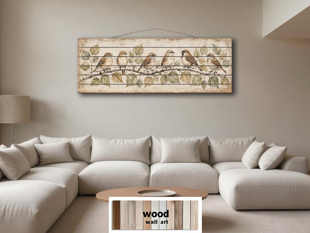 Panoramic wood wall art featuring sparrows on a birch branch above a modern sectional sofa.