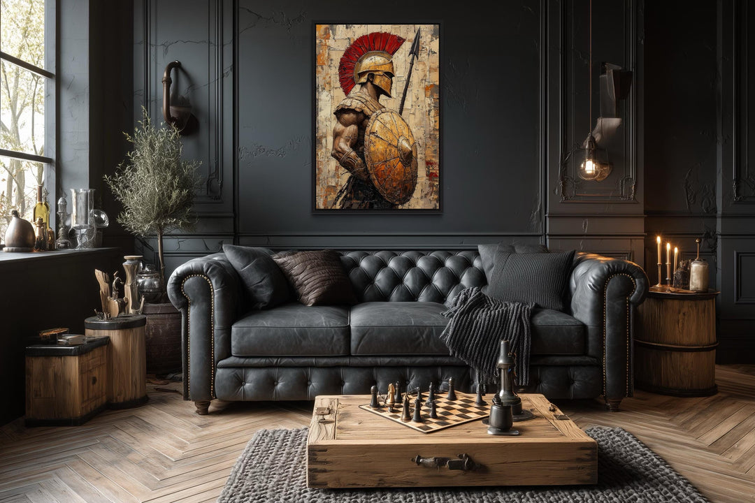 Spartan warrior canvas wall art with spear and shield above a black leather sofa in a dark room.