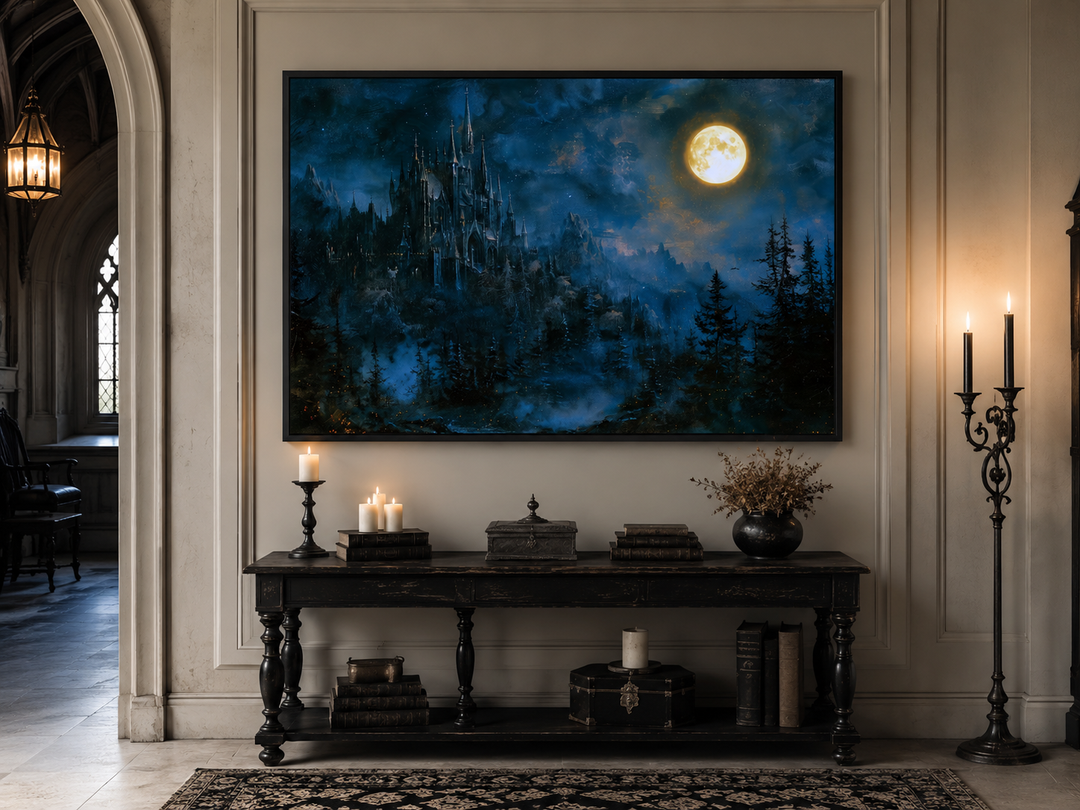Framed navy blue wall art of a gothic haunted castle under a full moon above a console table.