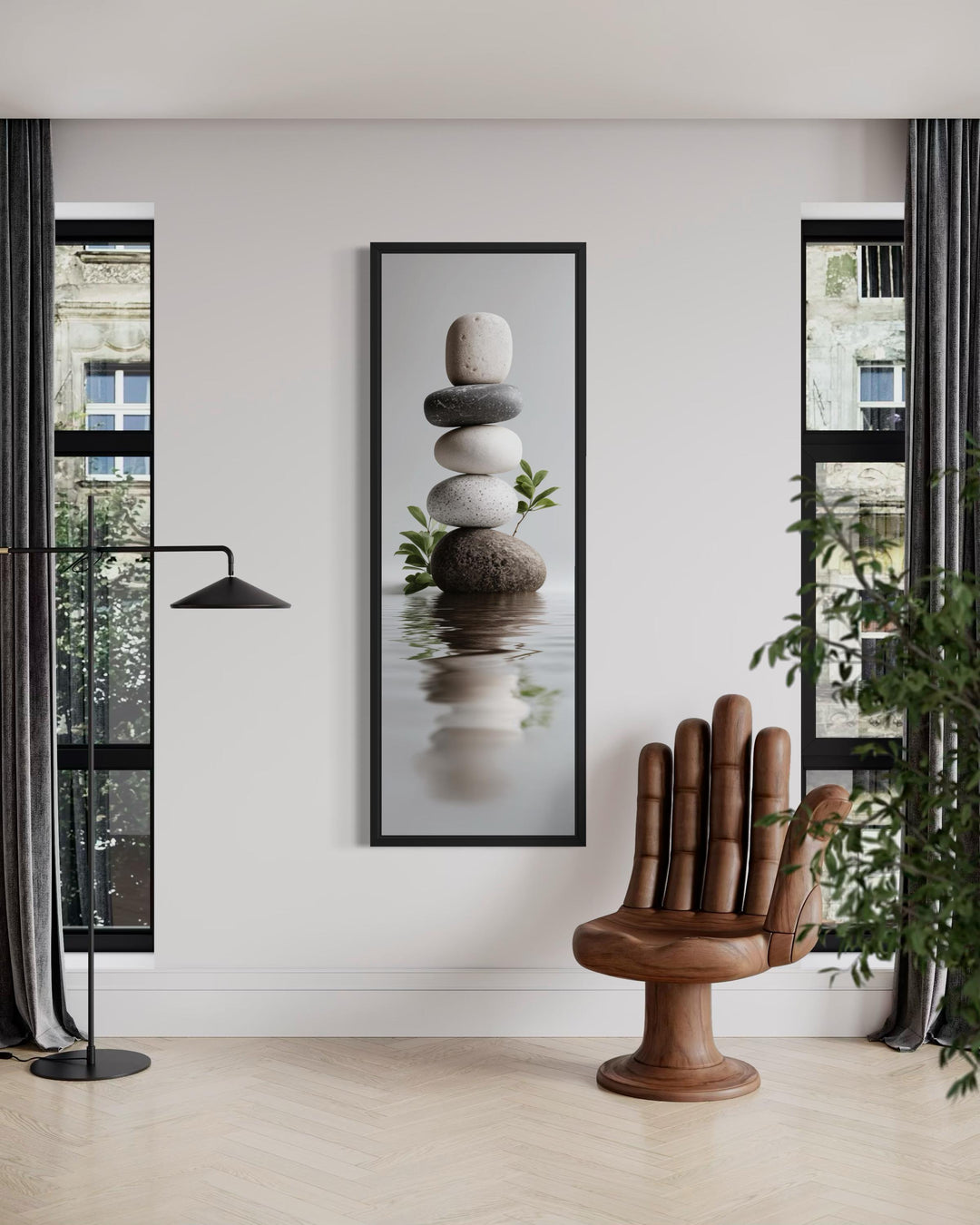 Tall narrow canvas wall art featuring a balanced stack of zen stones reflecting in calm water.